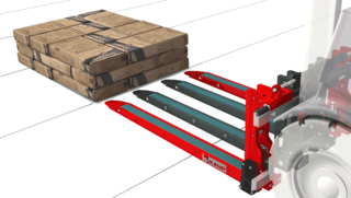 A stacker fork with four extendable tines drives towards a stack of packed building material