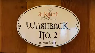Plaque with the inscription "St Kilian Washback No. 2 10800 litres" on a wooden base