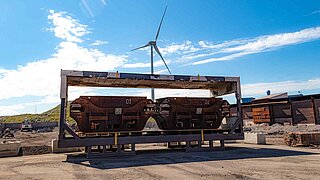 Two slag containers in a container without walls in front of an industrial area