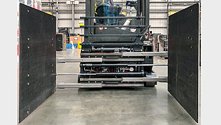 Front view of a forklift truck with Smart Load Control attachment open to the sides