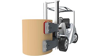 A silver forklift truck is equipped with a bale clamp holding a bale