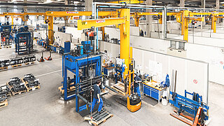 Several employees supervise the production of attachments in a KAUP factory plant