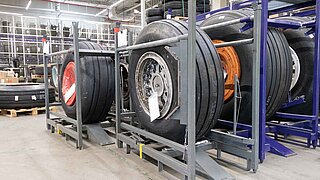 Individual aircraft tyres are stored individually in metal racks and in large quantities on shelves