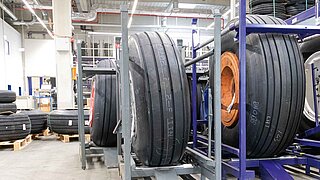View into a warehouse with aircraft tyres positioned in racks and on pallets