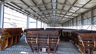 View into a hall with a large number of stored transport containers for slag collection